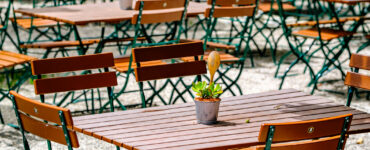 wooden benches and tables at a typical bavarian beergarden - photo