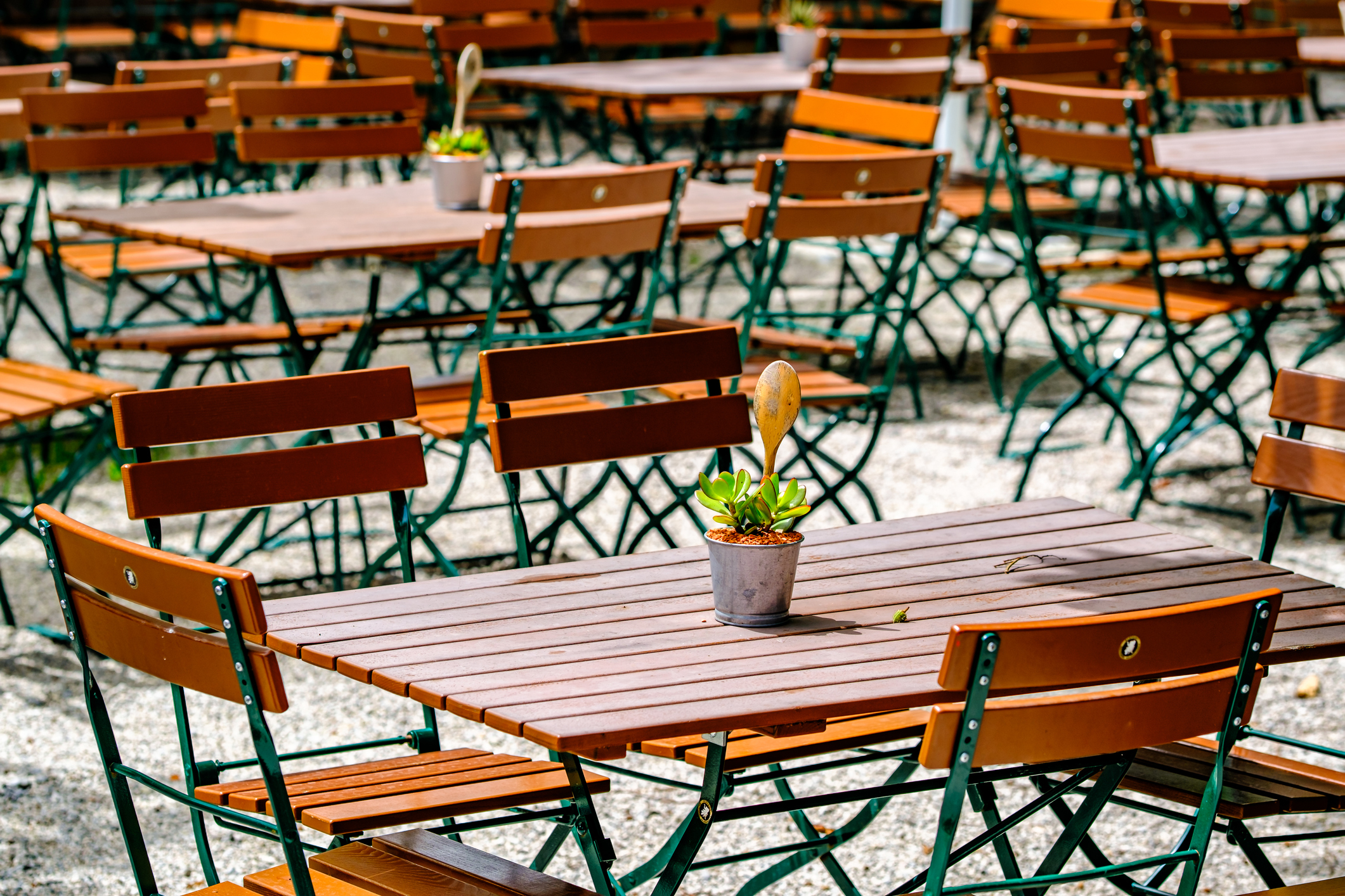 wooden benches and tables at a typical bavarian beergarden - photo